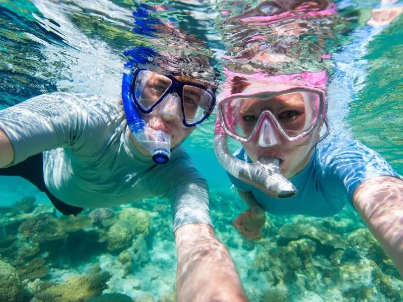 Family with children enjoying safe snorkeling tour in Trincomalee with professional guide